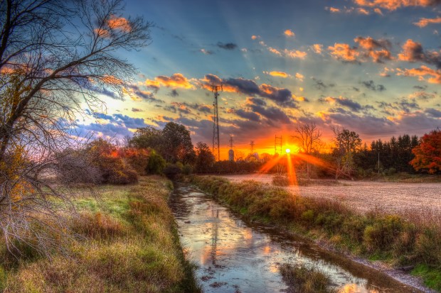 An image of a colourful sunset over Dingman Creek in London, Ontario