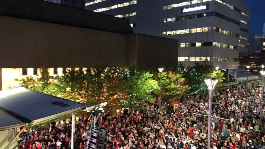 A crowd on Dundas Place watches a Toronto Raptors playoff game