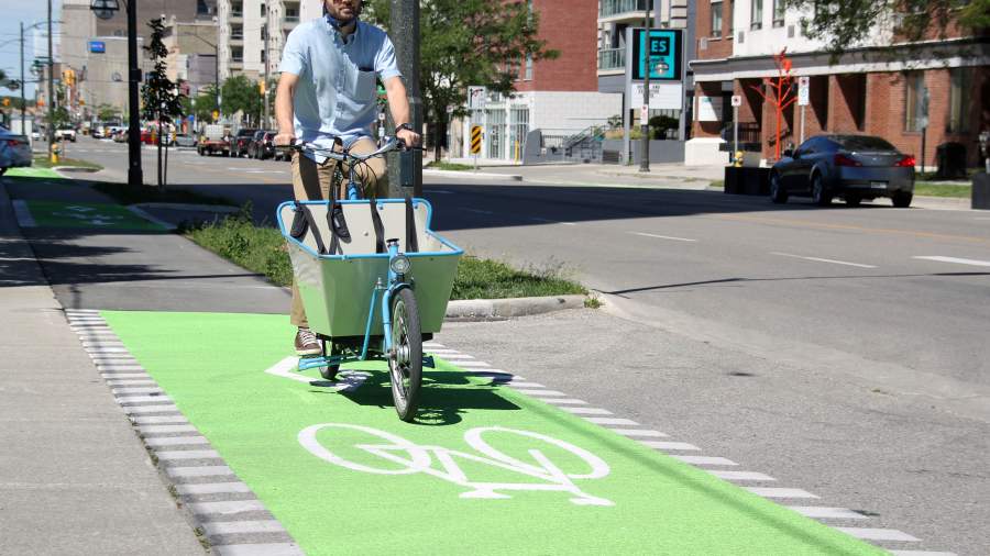 A man rides a bike in the Dundas Cycle Track downtown. 